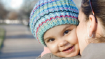 Woman kissing a baby's cheek