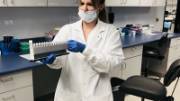 Lab technician holding equipment
