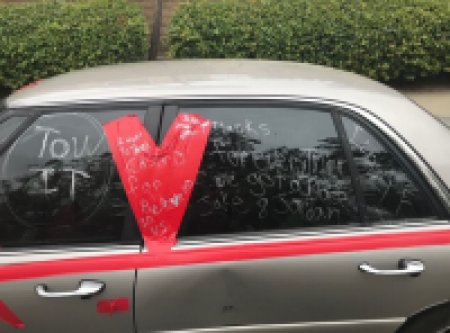 Vehicle with tape and writing on the windows