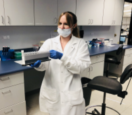 Lab technician holding equipment